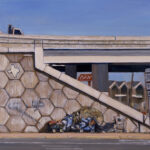 Oil painting of a homeless encampment at the base of a Texas highway overpass retaining wall covered in hexagonal tiles and graffiti. A shopping cart overflows with belongings under a camouflage tarp near directional signs for routes 290/71, with cars above on the bridge against a clear blue sky.